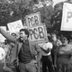 Rev. Ben Chavis, right, raises his fist as police arrest fellow protesters at the Warren County PCB landfill in Warren County, North Carolina, on September 16, 1982